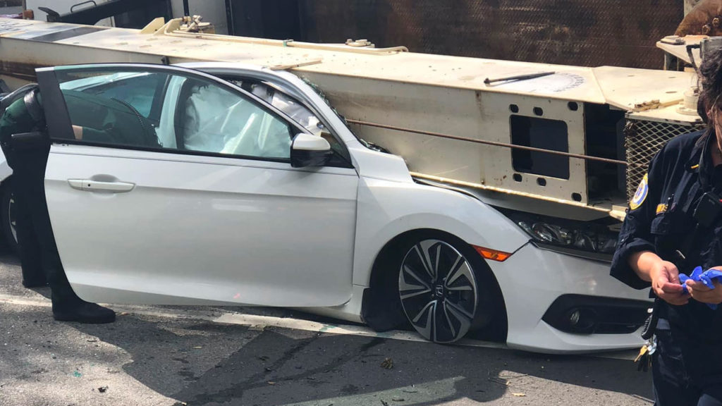 Crane truck overturned onto a Honda Civic near Chick-fil-a in Fort Walton Beach